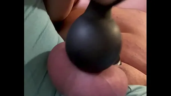 Hete has a tiny chastity on. Watch how much cum he has using a hitachi warme films