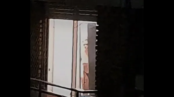Spying on a busty neighbor through the window Filem hangat panas